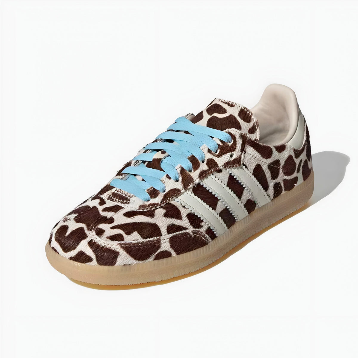 Sneaker with giraffe pattern and blue laces on a white background