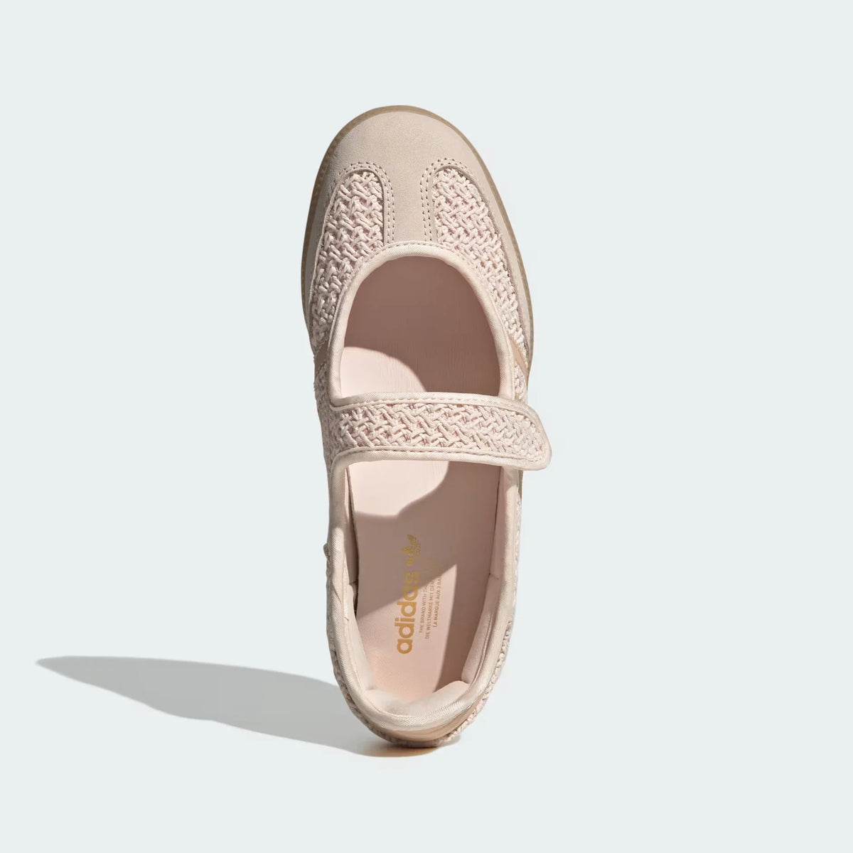 A single Adidas Mary Jane shoe in a light beige or pale blush pink color, shown from a top-down view on a light gray background.