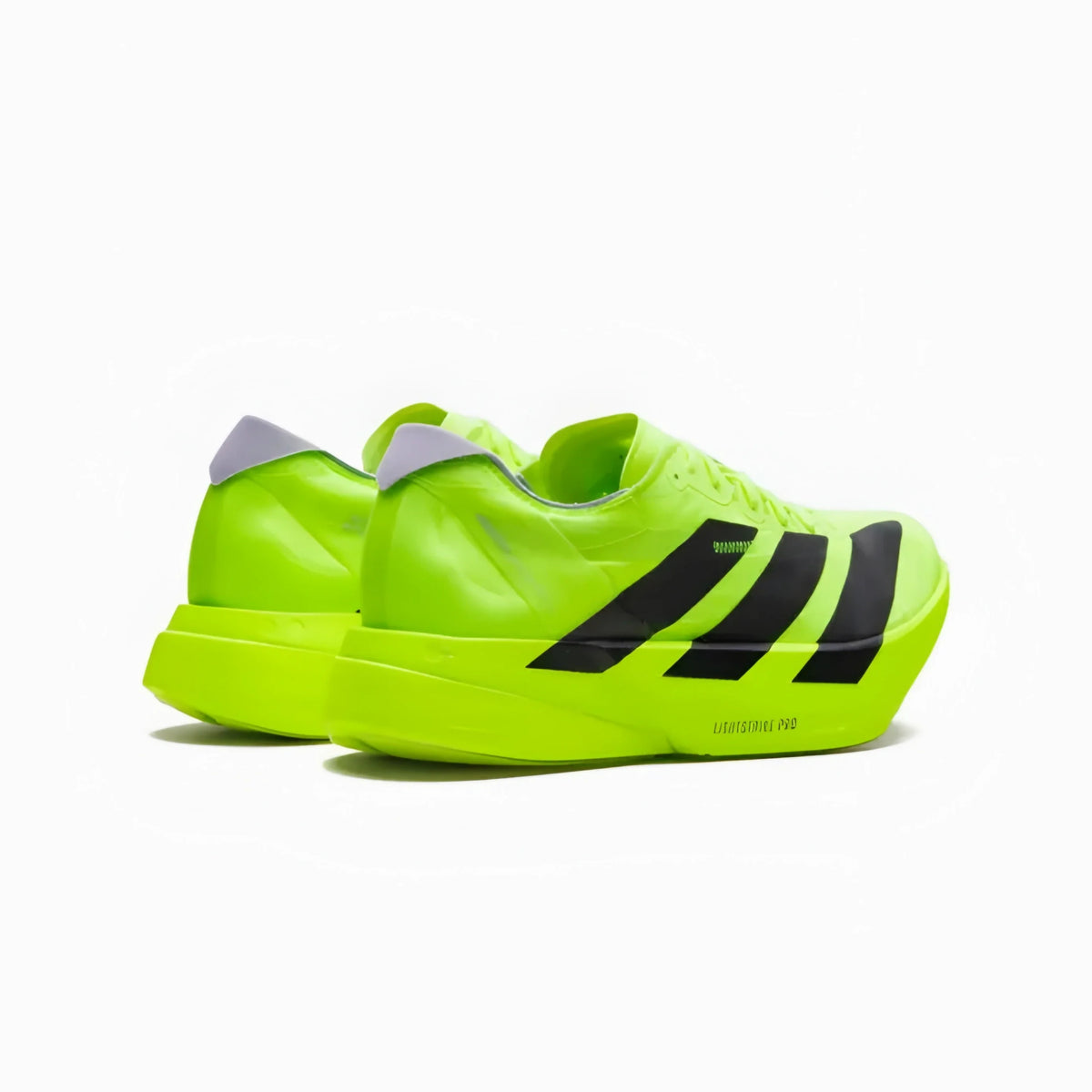 A pair of Adidas Samba sneakers in a vibrant neon yellow-green colorway, featuring three black stripes on the side and a gray heel tab, set against a plain white background.