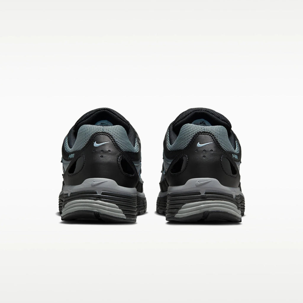 A pair of Nike P6000 running shoes shown from the rear, featuring a black and gray design with a light blue Nike Swoosh on the heel and tongue.