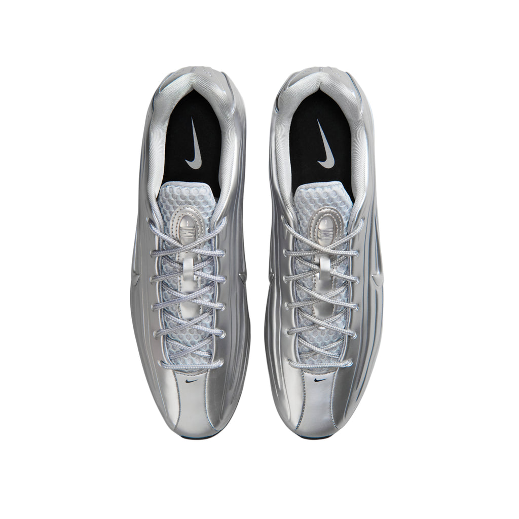 A pair of metallic silver Nike running shoes shown from a top-down view on a plain white background.