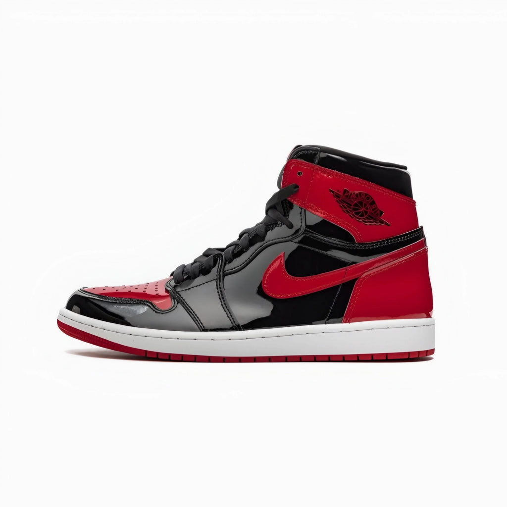A classic high-top sneaker in black and red, featuring a glossy black leather base, vibrant red overlays on the toe, heel, and collar, a black Nike Swoosh, and a white midsole.