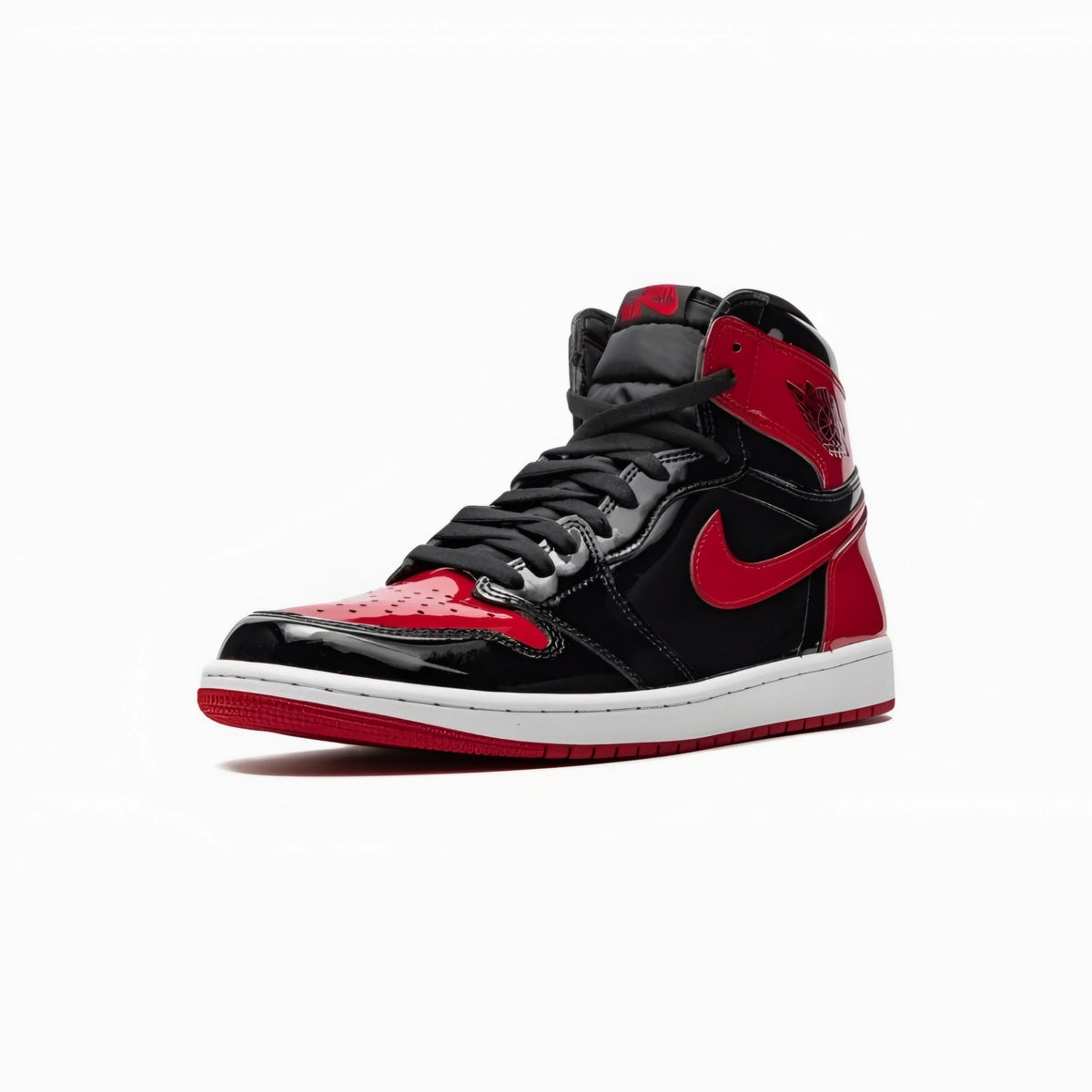 A classic high-top sneaker in black and red, featuring a glossy black leather upper with vibrant red overlays, a red Nike Swoosh, and a white midsole.