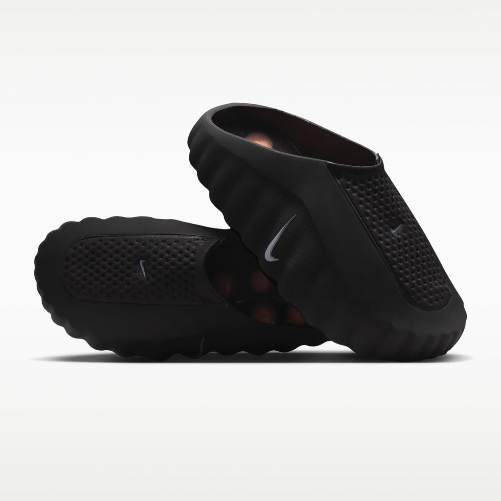 Black Nike mind sandals on a white background