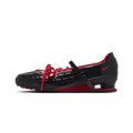 A black Nike shoe with red accents, featuring a glossy textured upper, red laces, a red swoosh, and a red heel counter, shown in a side profile on a white background.