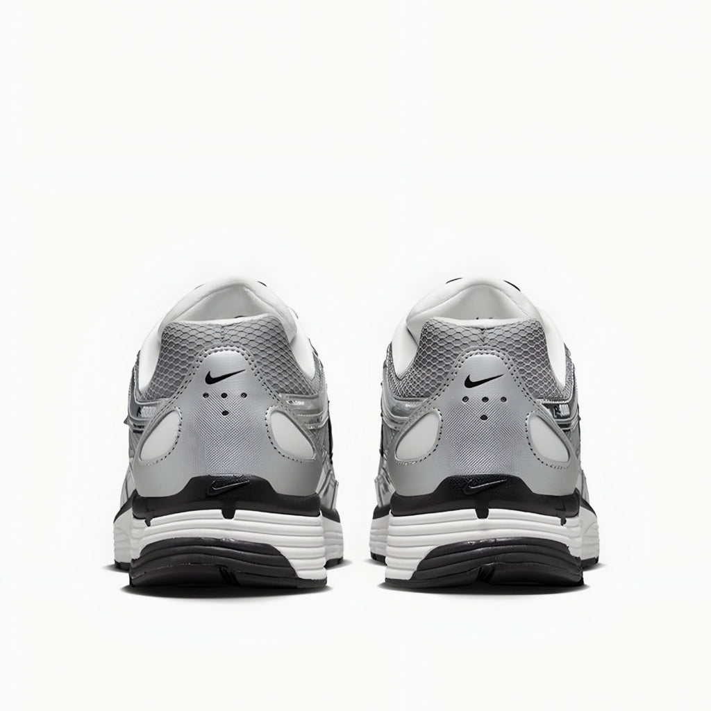 Gray and white athletic shoes with Nike logo on a white background