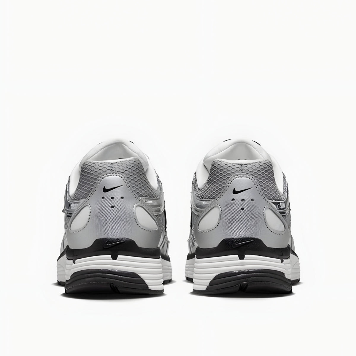 Gray and white athletic shoes with Nike logo on a white background